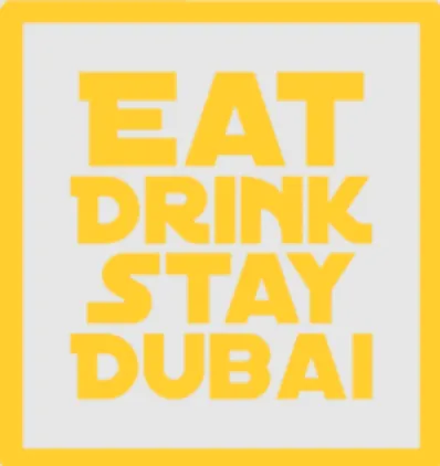 Yellow bold text reading 'EAT DRINK STAY DUBAI' on a light gray background with a yellow border.